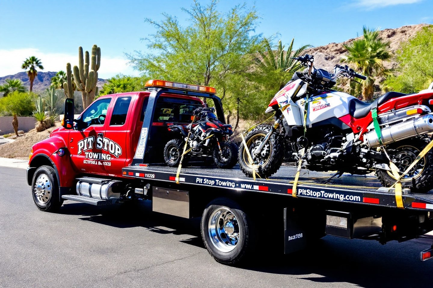 A red tow truck from Pit Stop Towing carrying a motorcycle and an ATV, showcasing professional motorcycle and ATV towing services.